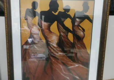 A framed painting of a group of dancers.