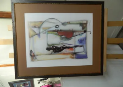 A framed painting of a man playing a guitar.